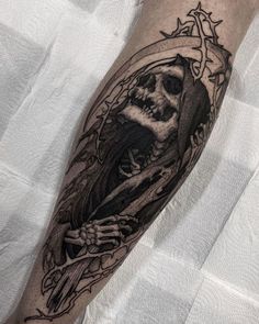 a man's arm with a skeleton and crown tattoo on it