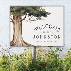 a welcome sign with a tree painted on it