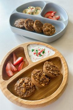 a wooden plate topped with cookies and fruit next to two bowls filled with yogurt