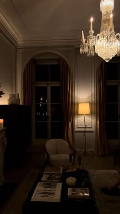 a living room filled with furniture and a chandelier