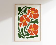 an orange and green floral print hangs on the wall