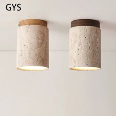 two concrete lamps are hanging from the ceiling