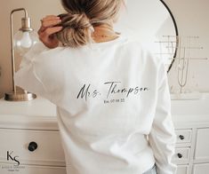 Now available as a T shirt https://www.etsy.com/ca/listing/1215698452/bride-custom-last-name-wedding-date?ref=listing_published_alert It's all in the Details.. This Modern design is a minimalist take on the ever popular 'bride' sweater. Wear your new last name loud and proud with this trendy 'business in the front, party in the back' sweater.  ----------- *The price reflects the printing on both front and back of the sweater* Composition and Production info: We proudly use Gilden brand crewneck Bride Sweater, Graphic Sweaters, Embroidered Wedding, The Medium, Bridal Shower Gift, Wedding Date, Printed Sweater, Crewneck Sweater, Crew Neck Sweater