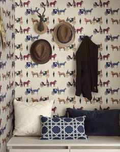 a bench with hats on it next to a wall mounted coat rack and hat racks