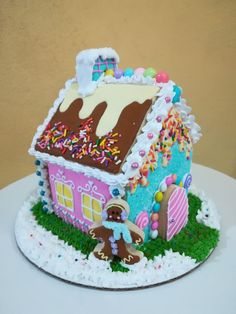 a decorated gingerbread house with sprinkles and icing