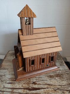 a wooden model of a church with bells