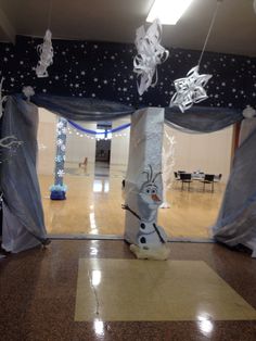 an indoor area decorated for christmas with snowflakes and decorations