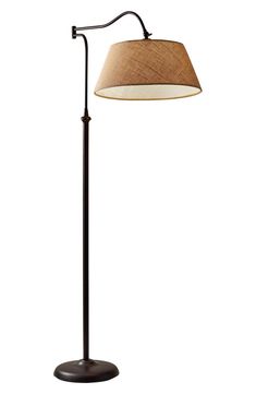 a floor lamp with a brown shade on the base and a white light behind it