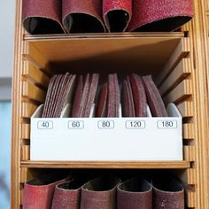 a shelf filled with lots of different types of sandpaper