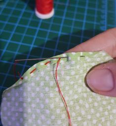 someone is sewing something on a piece of fabric