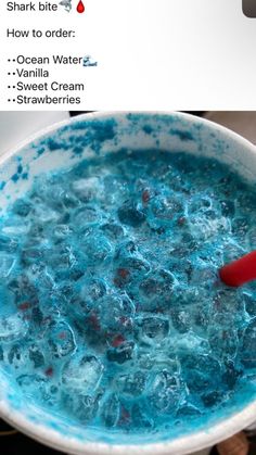 the bowl is full of blue liquid and has a red spoon in it that says shark to bite how to order ocean water sweet cream strawberries strawberries