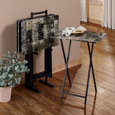 a table that has some kind of cloth on it next to a potted plant