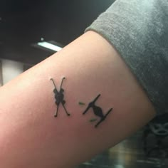 a couple of tattoos on the arm of someone's left arm, one with a spider and another with an antelope