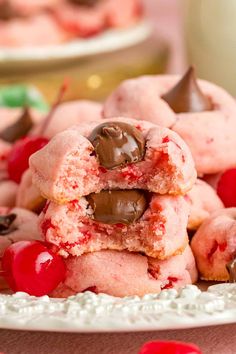 a white plate topped with cookies and cherries