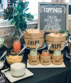 a table topped with lots of different types of dips and condiments next to a sign that says topings