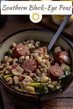 a bowl filled with beans, sausage and greens