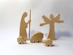 two wooden figurines with one holding a stick and the other looking at an elephant