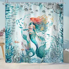 a shower curtain with an image of a mermaid swimming in the ocean and fish around it