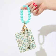 Stay stylish on-the-go with our wristlet keychain wallets – perfect for the do-it-all woman. Colorful silicone beads and a hexagonal wood accent offer mobility and convenience. Slip them on/off while running errands. This 3-in-1 accessory holds essentials like ID, credit card, cash, and keys. The leathered scallop design and chic tassel make a bold statement for gals with style. Keychain Wallets, Laura Park, Acrylic Picture Frames, Scallop Design, Tea Towel Gift, Keychain Wristlet, Wood Accent, Keychain Wallet, Linen Tea Towel