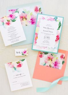 the wedding stationery is laid out on top of each other