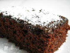 a piece of chocolate cake with powdered sugar on top