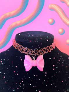 Bubblegum pink bow choker. Rubber choker stretches to fit neck comfortably. Adjustable Pink Trendy Choker, Pink Trendy Adjustable Choker, Pink Adjustable Trendy Choker, Pink Adjustable Choker As A Gift, Adjustable Pink Ribbon Necklace, Cute Pink Choker For Party, Pink Bow Necklace For Party, Adjustable Cute Pink Choker, Adjustable Bow Choker For Party