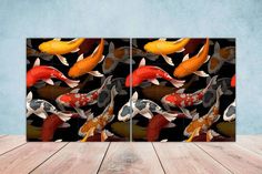 two panels with colorful koi fish in the water on a wooden table next to a blue wall