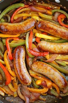 sausages and peppers are being cooked in a skillet