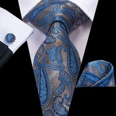 The Blue Paisley Silk Tie is a refined accessory that combines classic elegance with a vibrant twist. Featuring an intricate paisley pattern in varying shades of blue, this tie exudes sophistication and style. Made from high-quality silk, it has a smooth texture and a subtle sheen that enhances its luxurious appeal. The blue palette makes it versatile enough to pair with a wide range of outfits, from formal suits to more casual blazers, adding a touch of personality while maintaining a polished Blue Necktie, Necktie Set, Business Party, Paisley Tie, Cufflink Set, Modern Gentleman, Luxury Silk, Mens Neck Ties, Tie Set