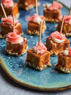 small desserts are arranged on a blue plate