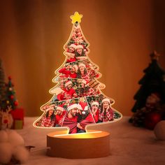 a lighted christmas tree with pictures on it