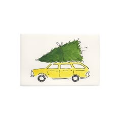 a yellow car with a christmas tree on top