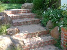 the steps are made out of bricks and have plants growing on them