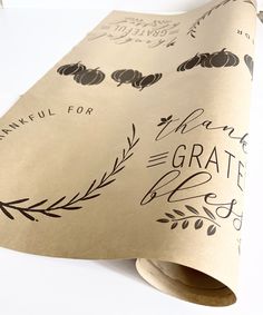 a roll of paper with black lettering on it that says thanksgiving for the grate