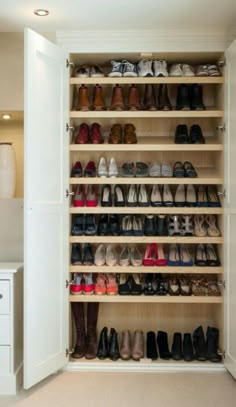 a closet filled with lots of pairs of shoes