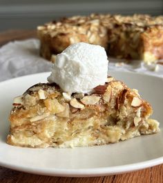 a piece of pie on a white plate with a scoop of ice cream on top