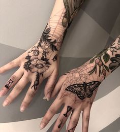 two hands with tattoos on them, one has a butterfly and the other has flowers