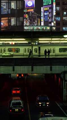 people are standing on the roof of a subway car at night in tokyo, japan