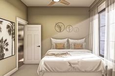 a bedroom with a bed, ceiling fan and two pictures on the wall above it