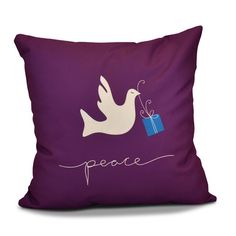 a purple pillow with a white dove holding a blue gift box and the word peace on it