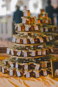 there are many jars that have honey in them on the table with tags attached to them