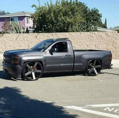 a silver truck parked in a parking lot