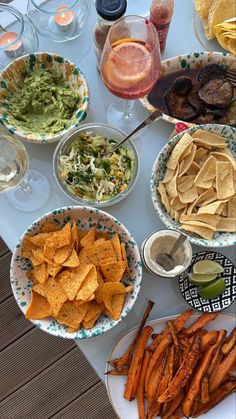 a table filled with plates and bowls of food