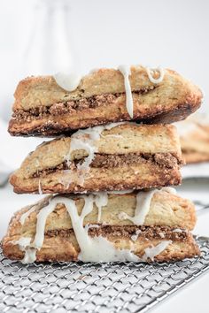 three cookies stacked on top of each other with icing drizzled around them