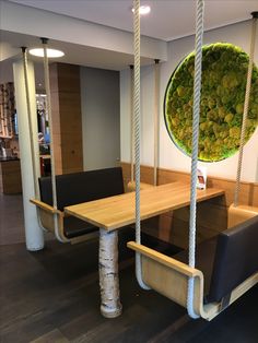 a wooden table sitting next to two black chairs