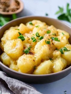 a bowl filled with potatoes and garnished with parsley