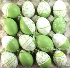 green and white decorated eggs in a cardboard box