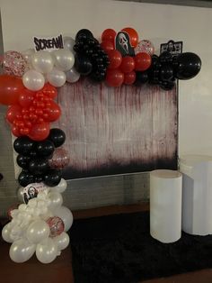 an arch made out of balloons and other decorations