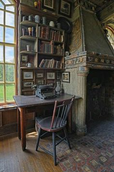 an old fashioned desk and chair in front of a fireplace