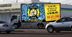 an advertisement on the back of a semi truck in front of a building with other vehicles